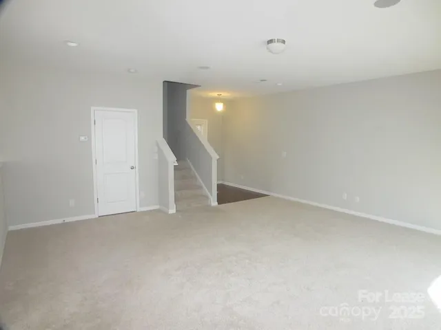 a view of an empty room with stairs