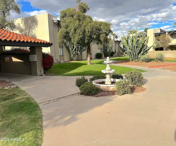 a view of a patio with table and chairs potted plants