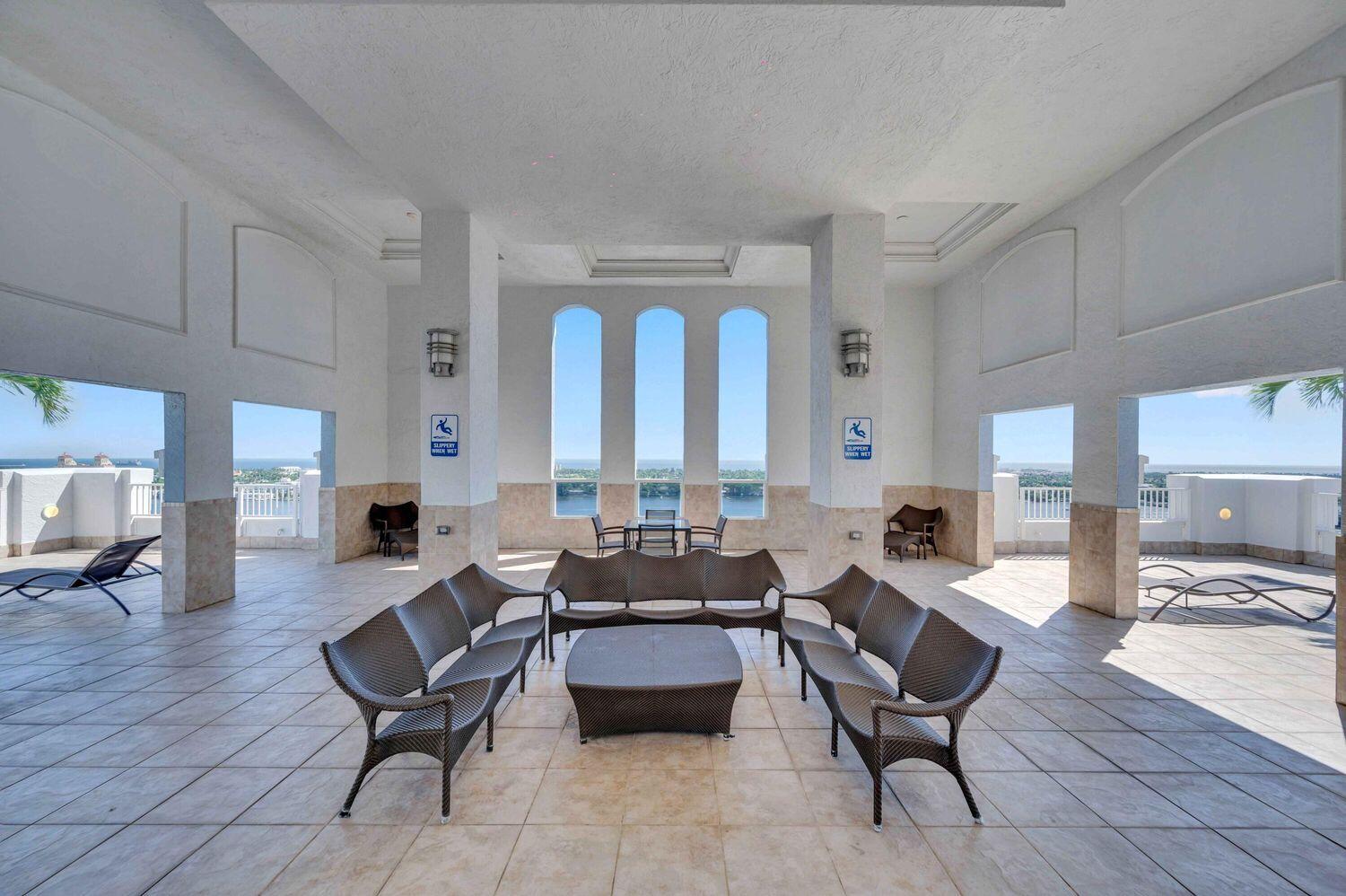 255 Evernia Street, Unit 407 West Palm Beach, FL 33401 - Photo 27 of 31 a living room with fireplace furniture and a large window