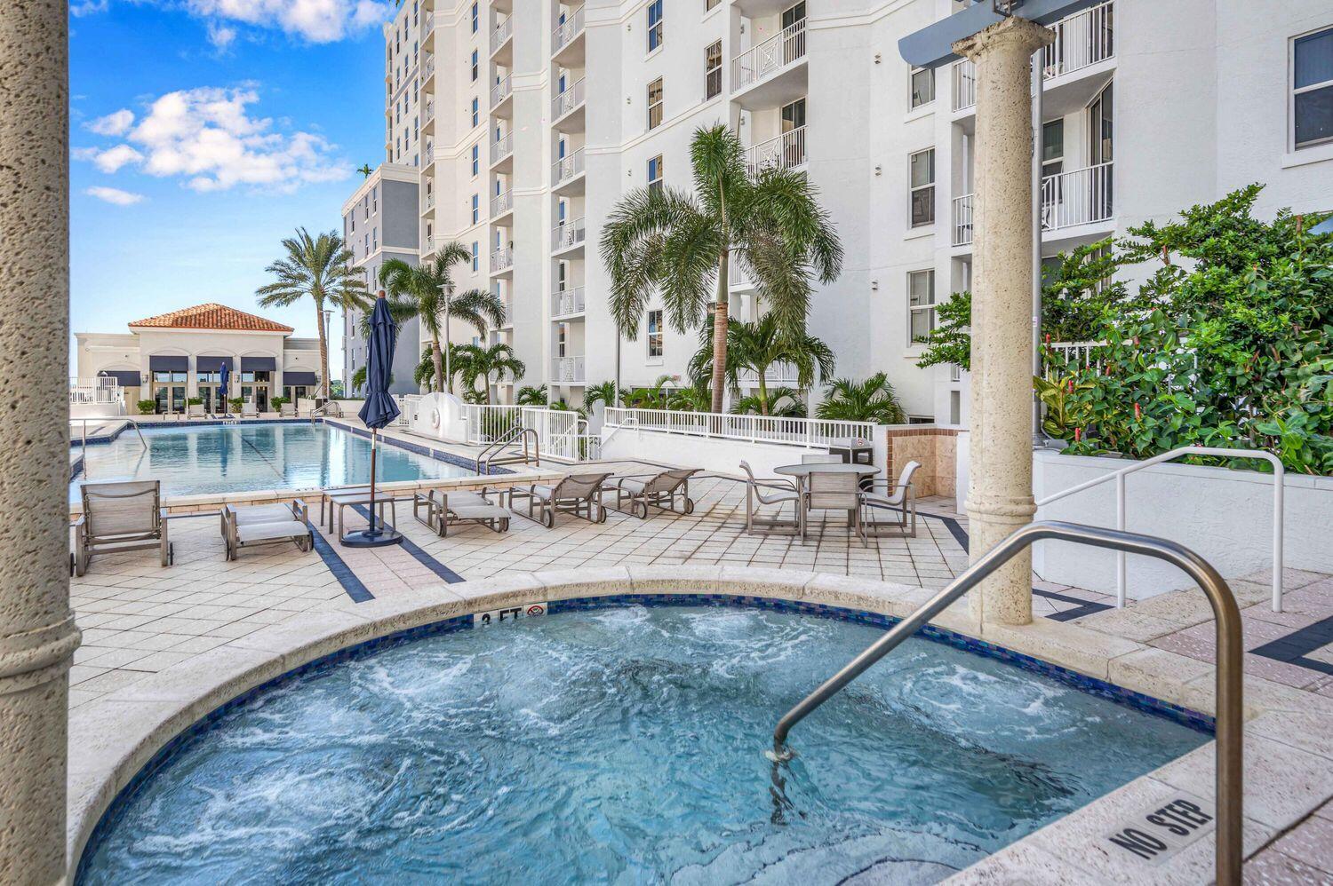 255 Evernia Street, Unit 407 West Palm Beach, FL 33401 - Photo 30 of 31 a view of a swimming pool with outdoor seating and plants