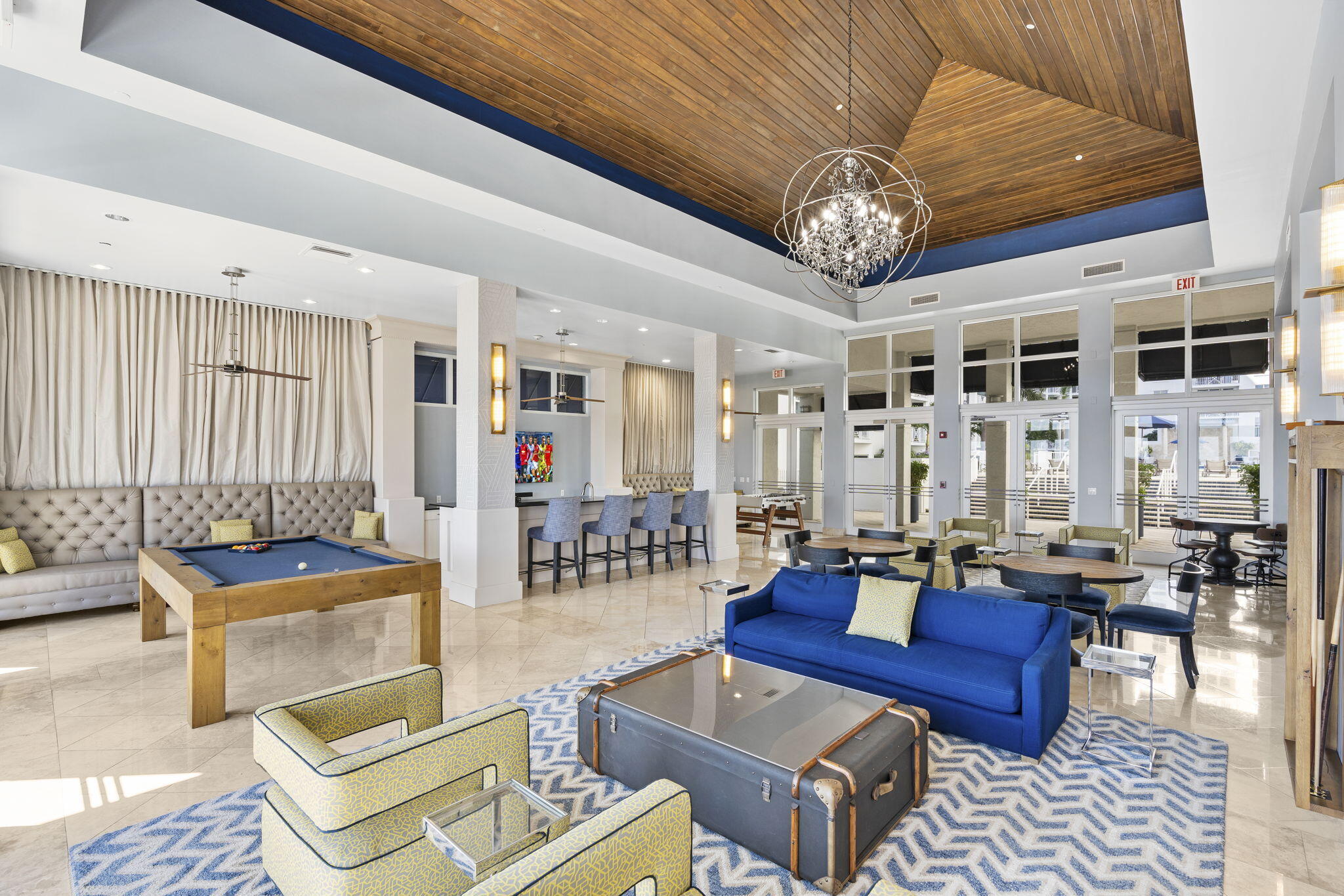 255 Evernia Street, Unit 407 West Palm Beach, FL 33401 - Photo 7 of 31 a living room with furniture a rug and a chandelier