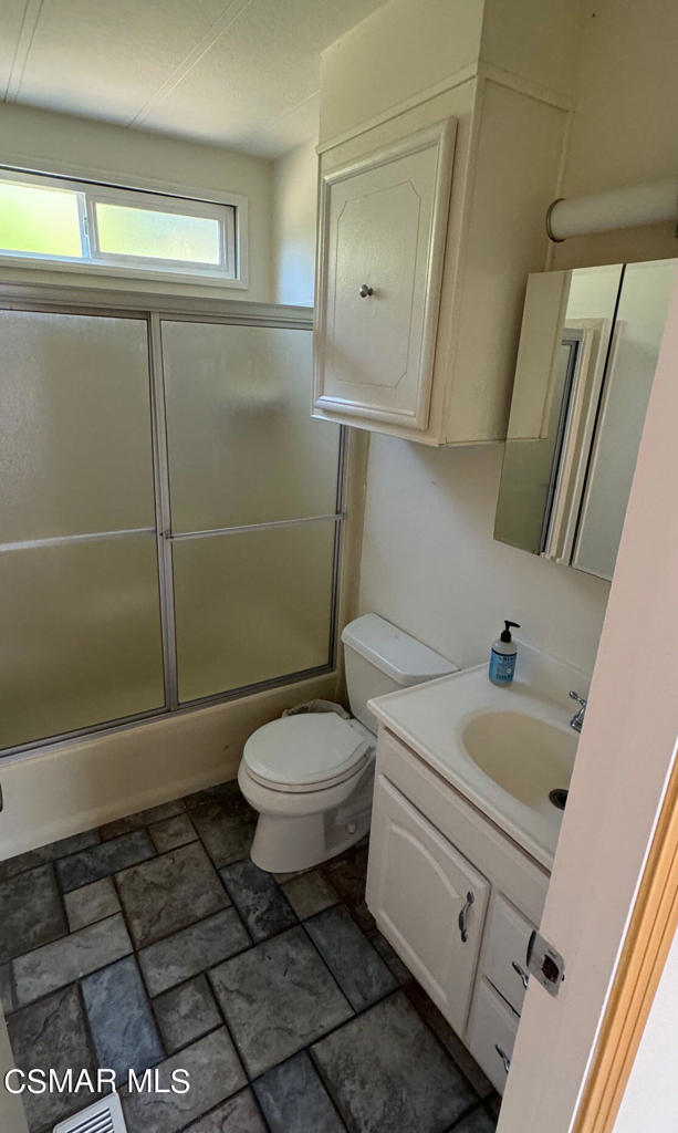 24303 Woolsey Canoga Park, Unit 26 Los Angeles, CA 90068 - Photo 12 of 28 a bathroom with a sink a toilet and a mirror