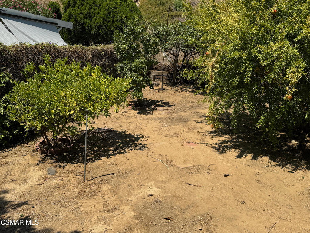 24303 Woolsey Canoga Park, Unit 26 Los Angeles, CA 90068 - Photo 21 of 28 a view of a yard covered in snow