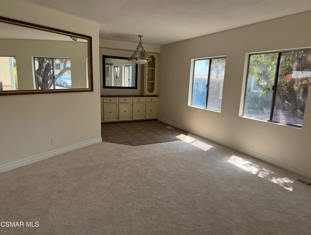 24303 Woolsey Canoga Park, Unit 26 Los Angeles, CA 90068 - Photo 4 of 28 an empty room with windows and cabinet