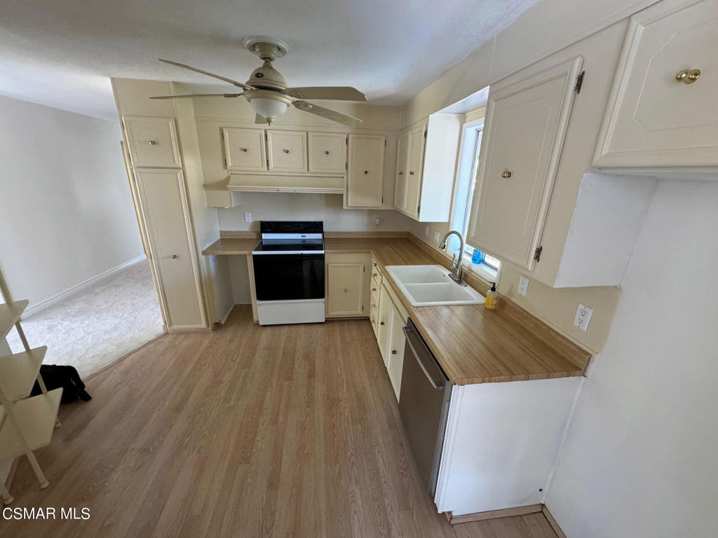 24303 Woolsey Canoga Park, Unit 26 Los Angeles, CA 90068 - Photo 6 of 28 a kitchen with a sink appliances and cabinets
