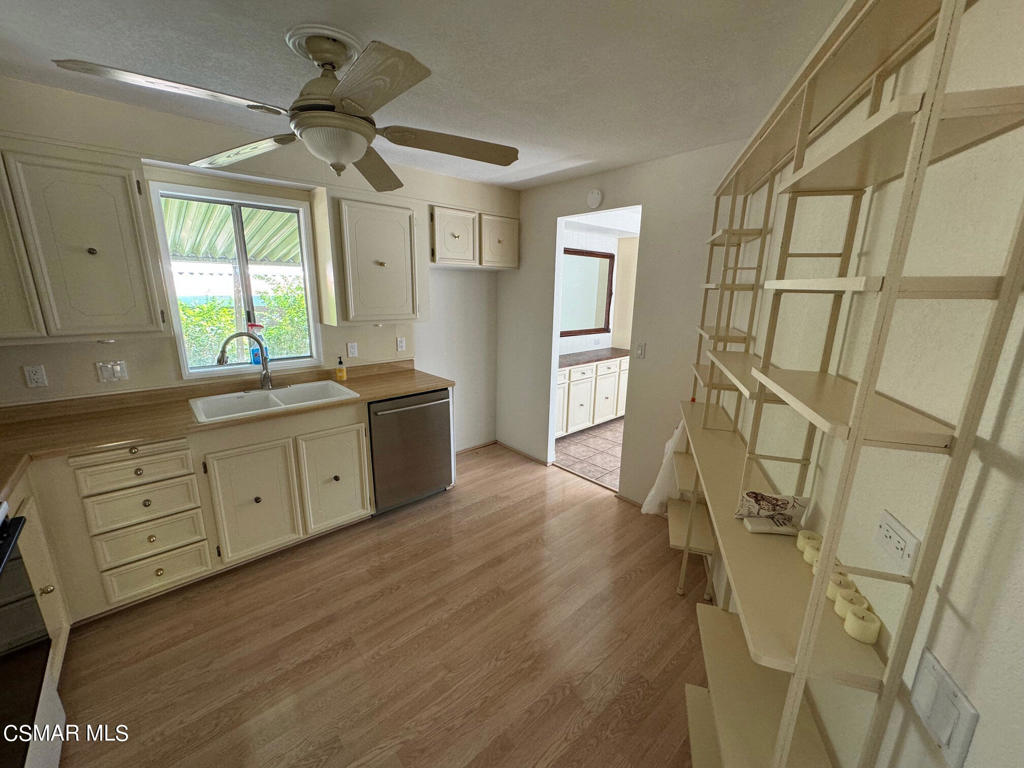 24303 Woolsey Canoga Park, Unit 26 Los Angeles, CA 90068 - Photo 7 of 28 a kitchen with stainless steel appliances a lot of counter space and a window
