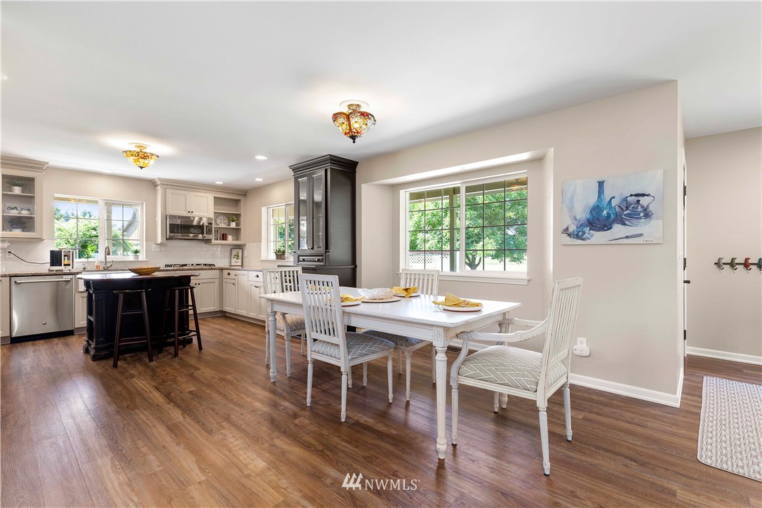 9451 Avon Allen Road Bow, WA 98232 - Photo 11 of 40 a view of a dining room with furniture window and wooden floor