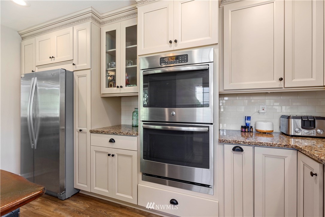 9451 Avon Allen Road Bow, WA 98232 - Photo 13 of 40 a kitchen with stainless steel appliances white cabinets and a refrigerator
