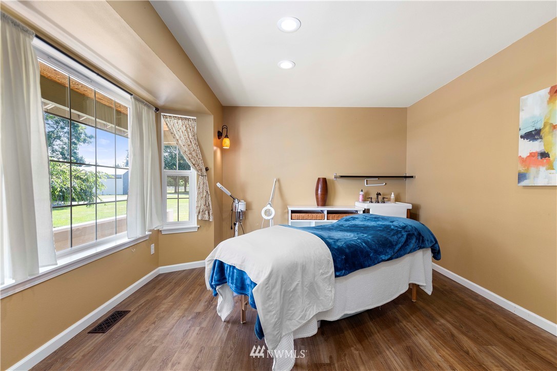 9451 Avon Allen Road Bow, WA 98232 - Photo 19 of 40 a bed sitting in a bedroom next to a window