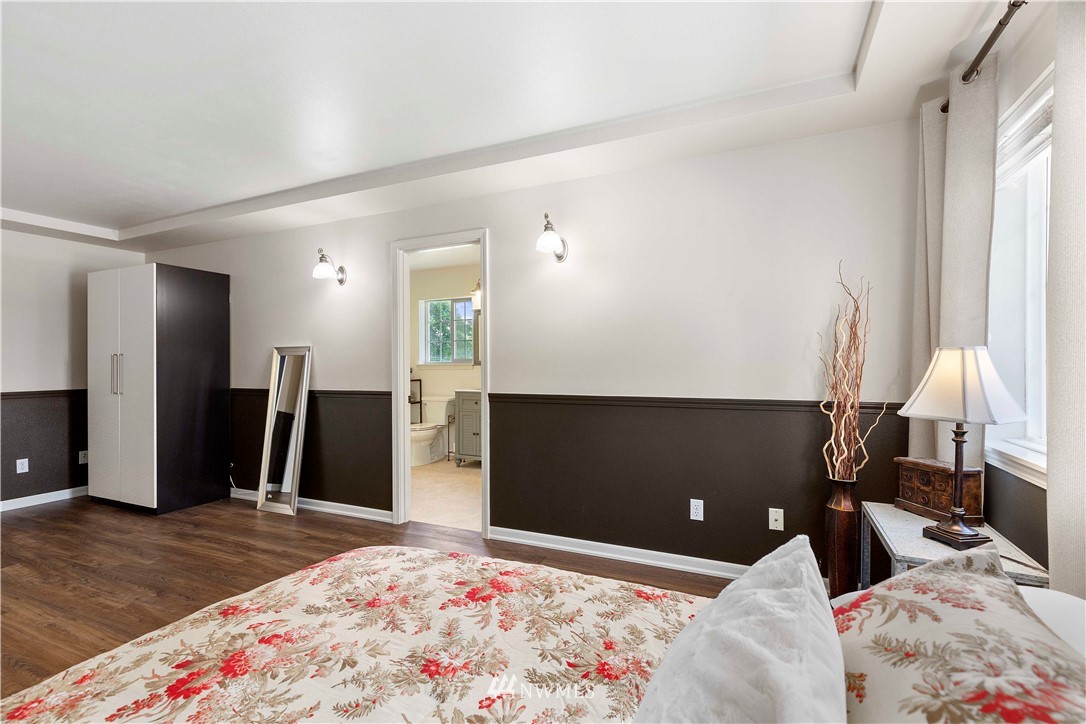 9451 Avon Allen Road Bow, WA 98232 - Photo 22 of 40 a bedroom with a bed and a dresser