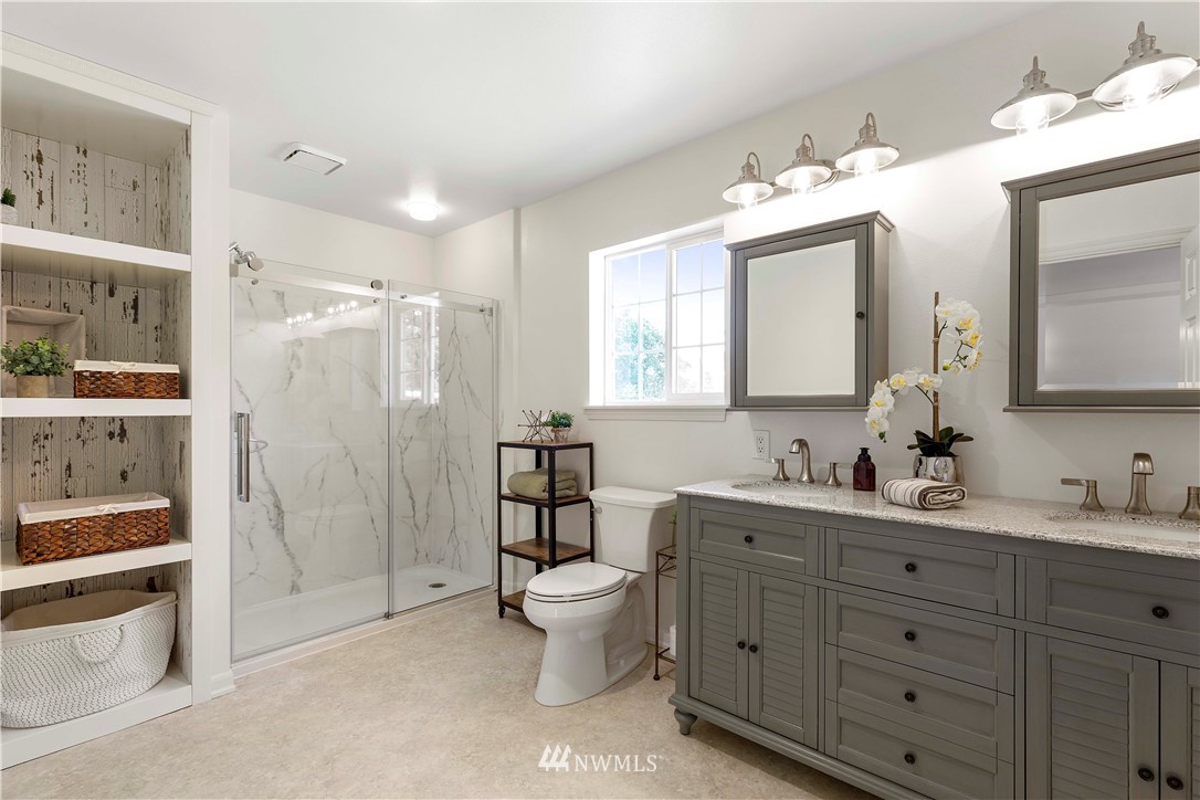 9451 Avon Allen Road Bow, WA 98232 - Photo 23 of 40 a bathroom with a double vanity sink mirror and shower