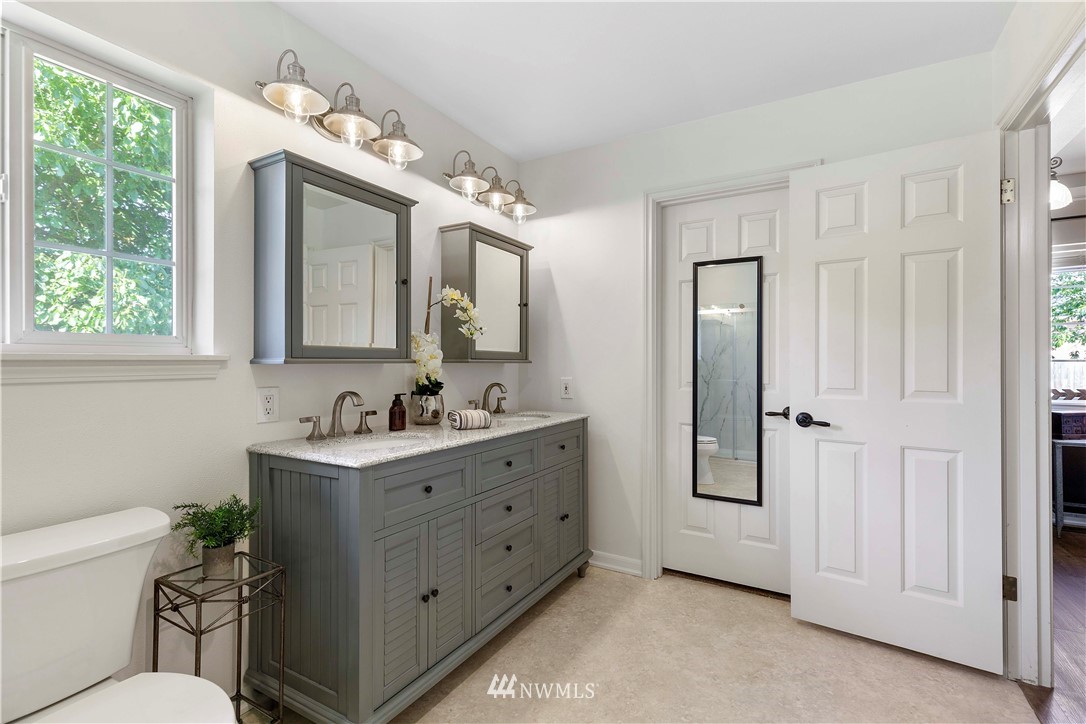 9451 Avon Allen Road Bow, WA 98232 - Photo 24 of 40 a bathroom with a double vanity sink mirror and toilet