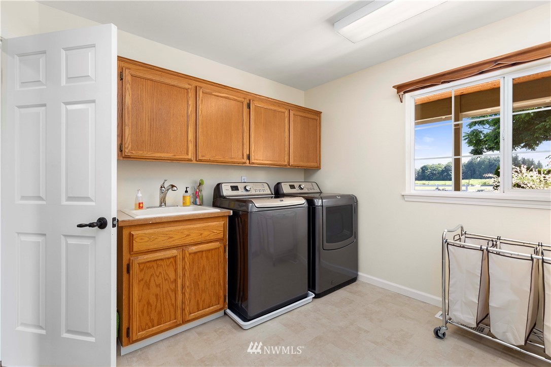 9451 Avon Allen Road Bow, WA 98232 - Photo 25 of 40 a utility room with sink dryer and washer