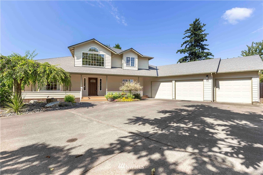 9451 Avon Allen Road Bow, WA 98232 - Photo 4 of 40 a view of a house with a yard and garage