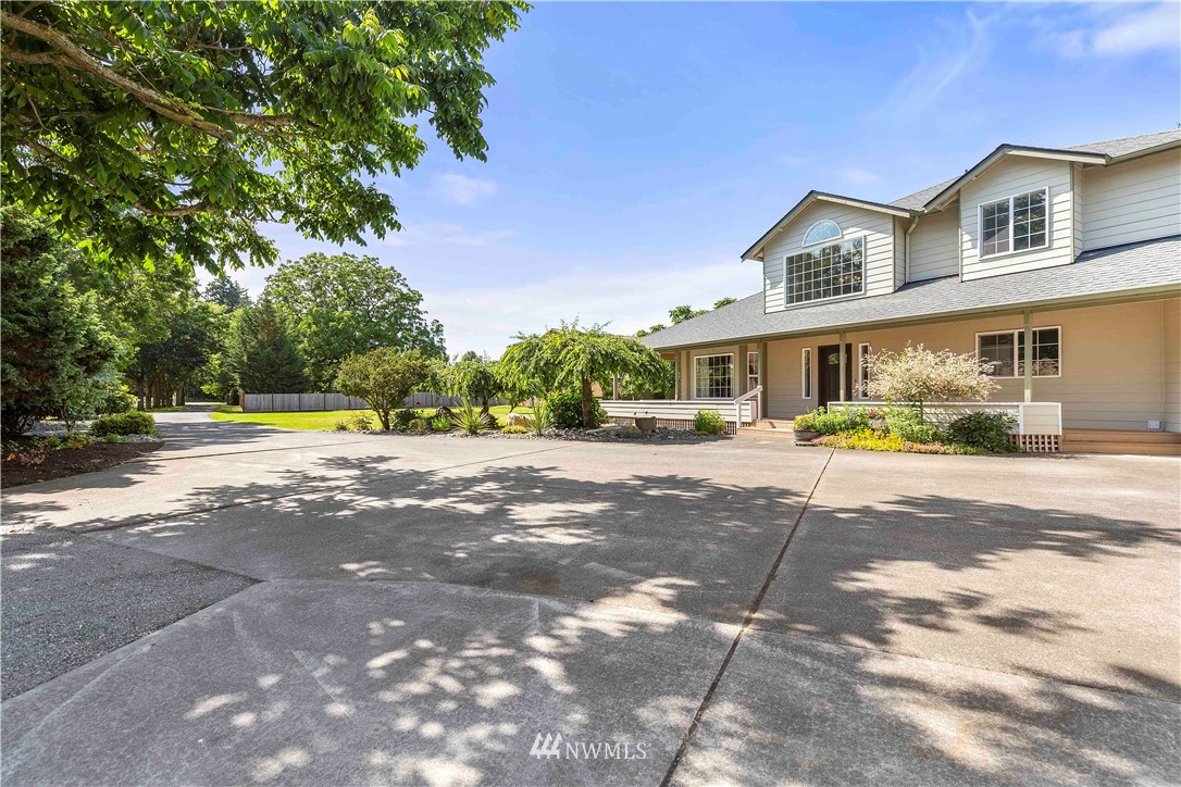 9451 Avon Allen Road Bow, WA 98232 - Photo 33 of 40 a front view of a house with a yard and potted plants