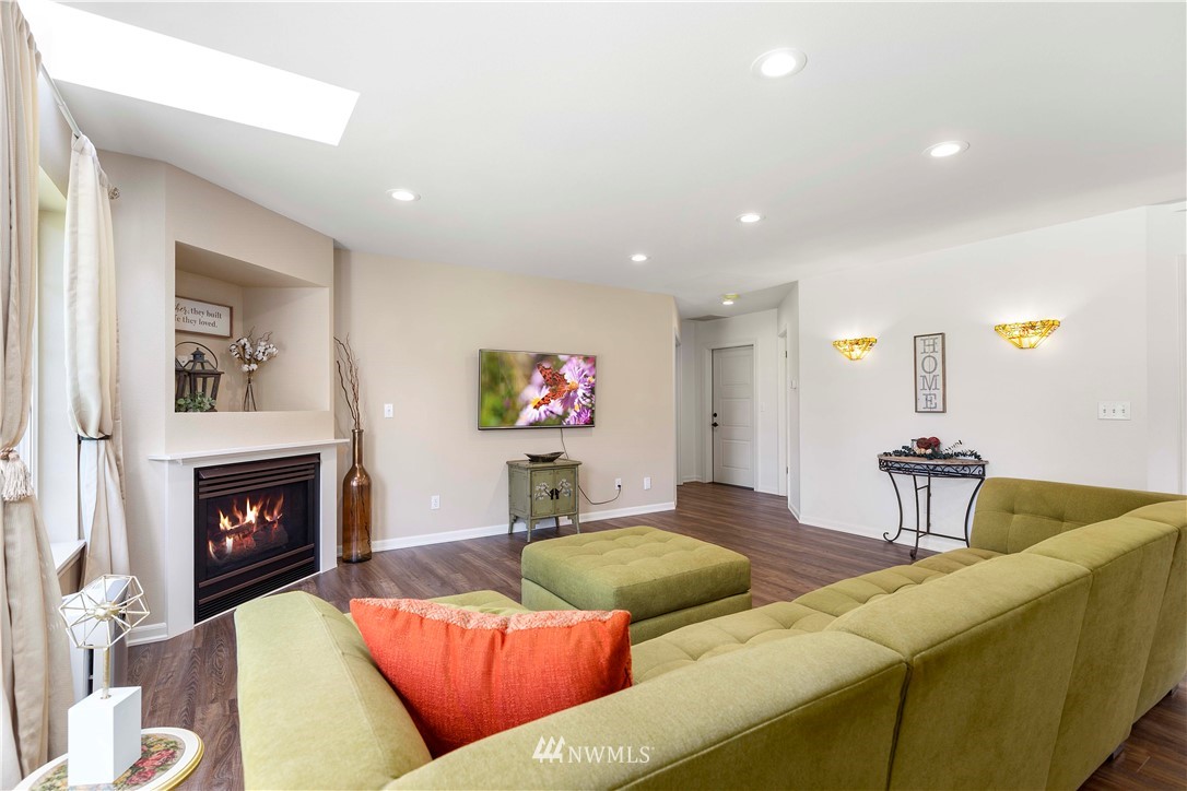 9451 Avon Allen Road Bow, WA 98232 - Photo 7 of 40 a living room with furniture and a fireplace