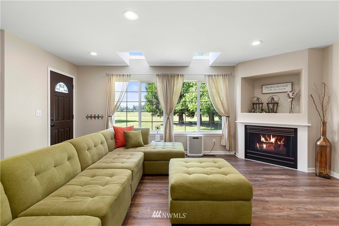 9451 Avon Allen Road Bow, WA 98232 - Photo 8 of 40 a living room with furniture and a fireplace