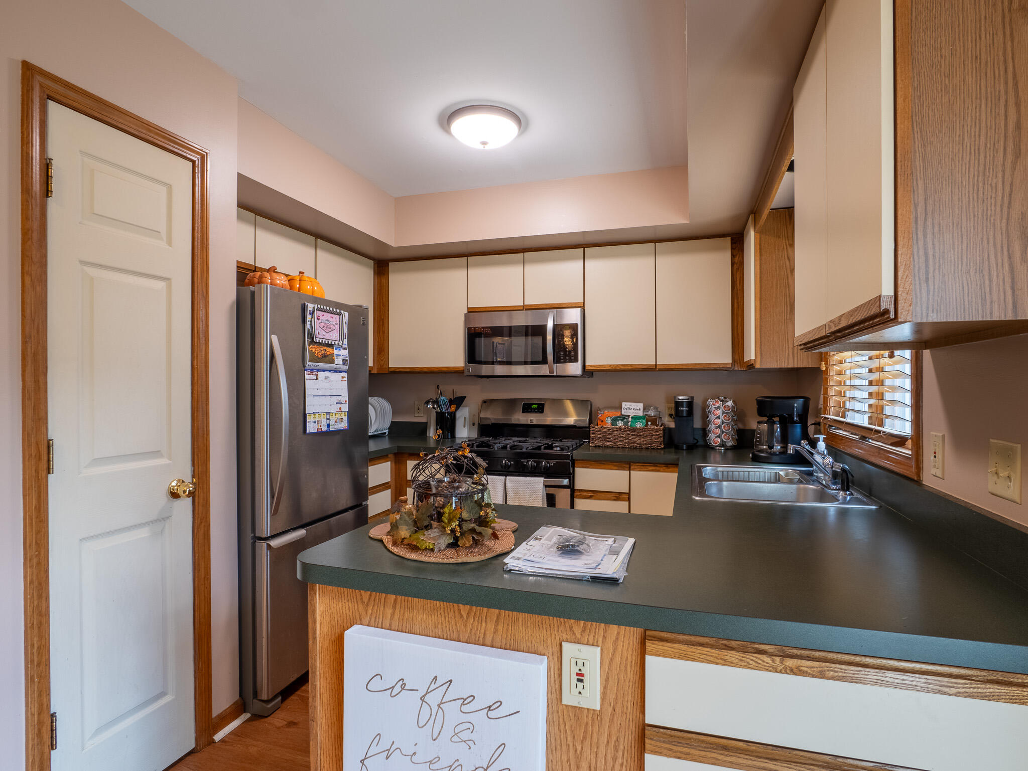1362 West 94th Court Crown Point, IN 46307 - Photo 8 of 23 a kitchen with a refrigerator a stove a microwave and cabinets