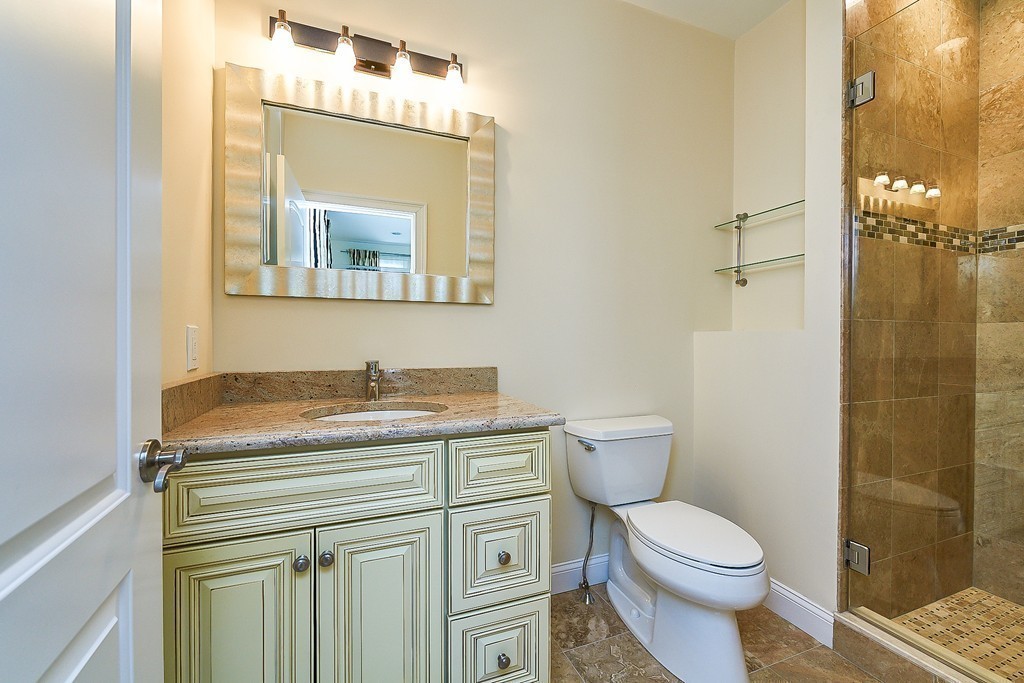 17 Drew Road Newton, MA 02467 - Photo 16 of 22 a bathroom with a granite countertop toilet sink and mirror