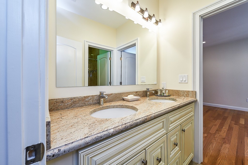 17 Drew Road Newton, MA 02467 - Photo 17 of 22 a bathroom with a granite countertop sink and a mirror