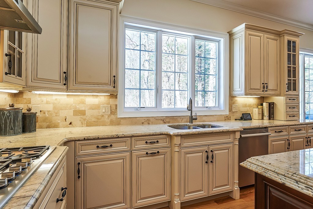 17 Drew Road Newton, MA 02467 - Photo 7 of 22 a kitchen with stainless steel appliances granite countertop a sink stove and cabinets