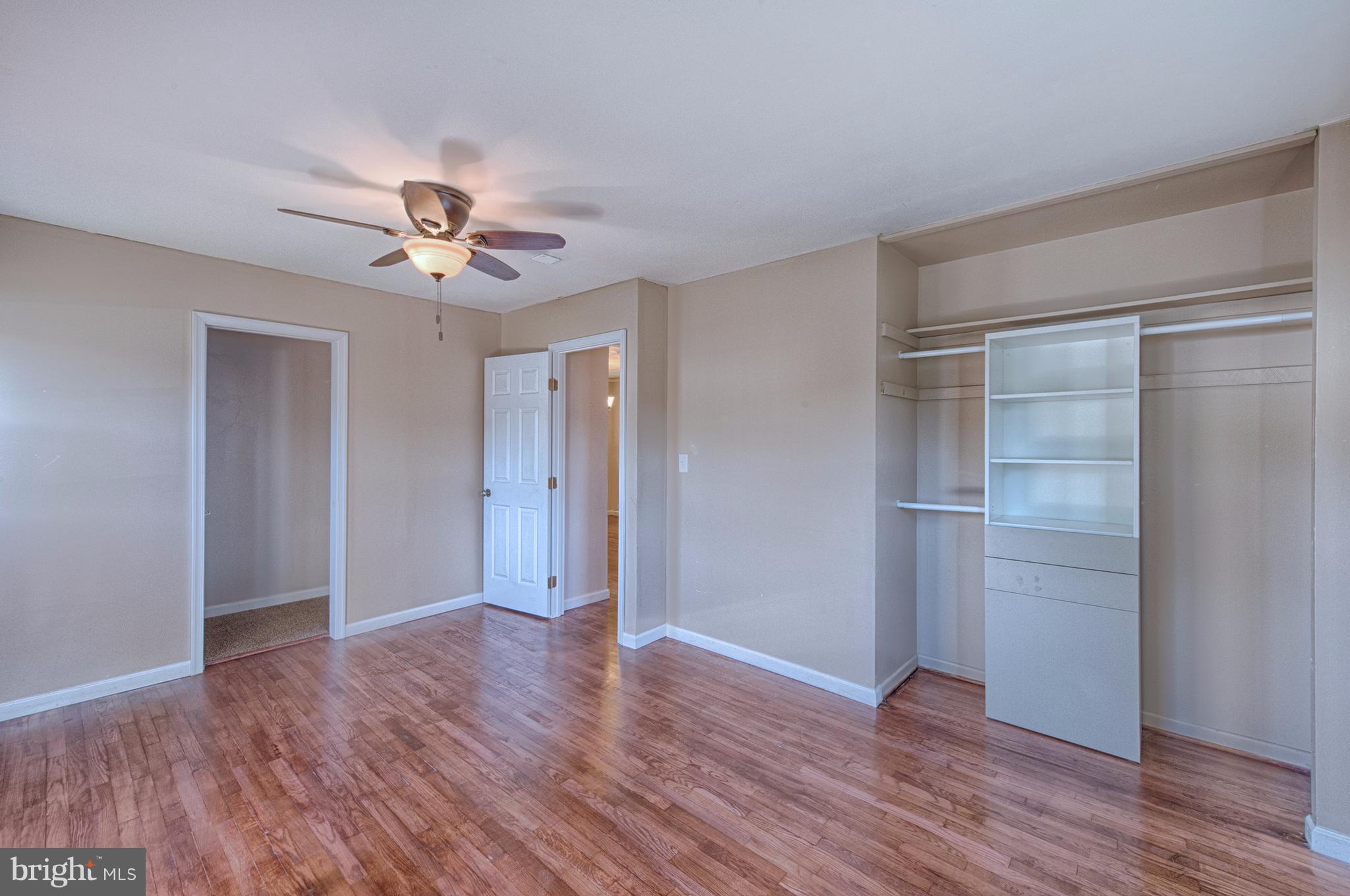 529 Crisfield Road Baltimore, MD 21220 - Photo 14 of 19 a view of an empty room with wooden floor