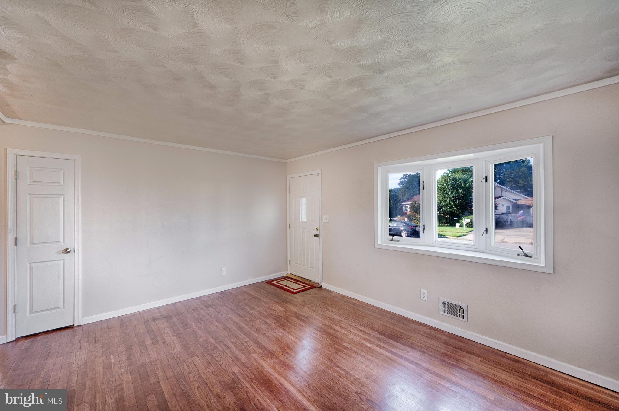 529 Crisfield Road Baltimore, MD 21220 - Photo 3 of 19 a big room with wooden floor and windows