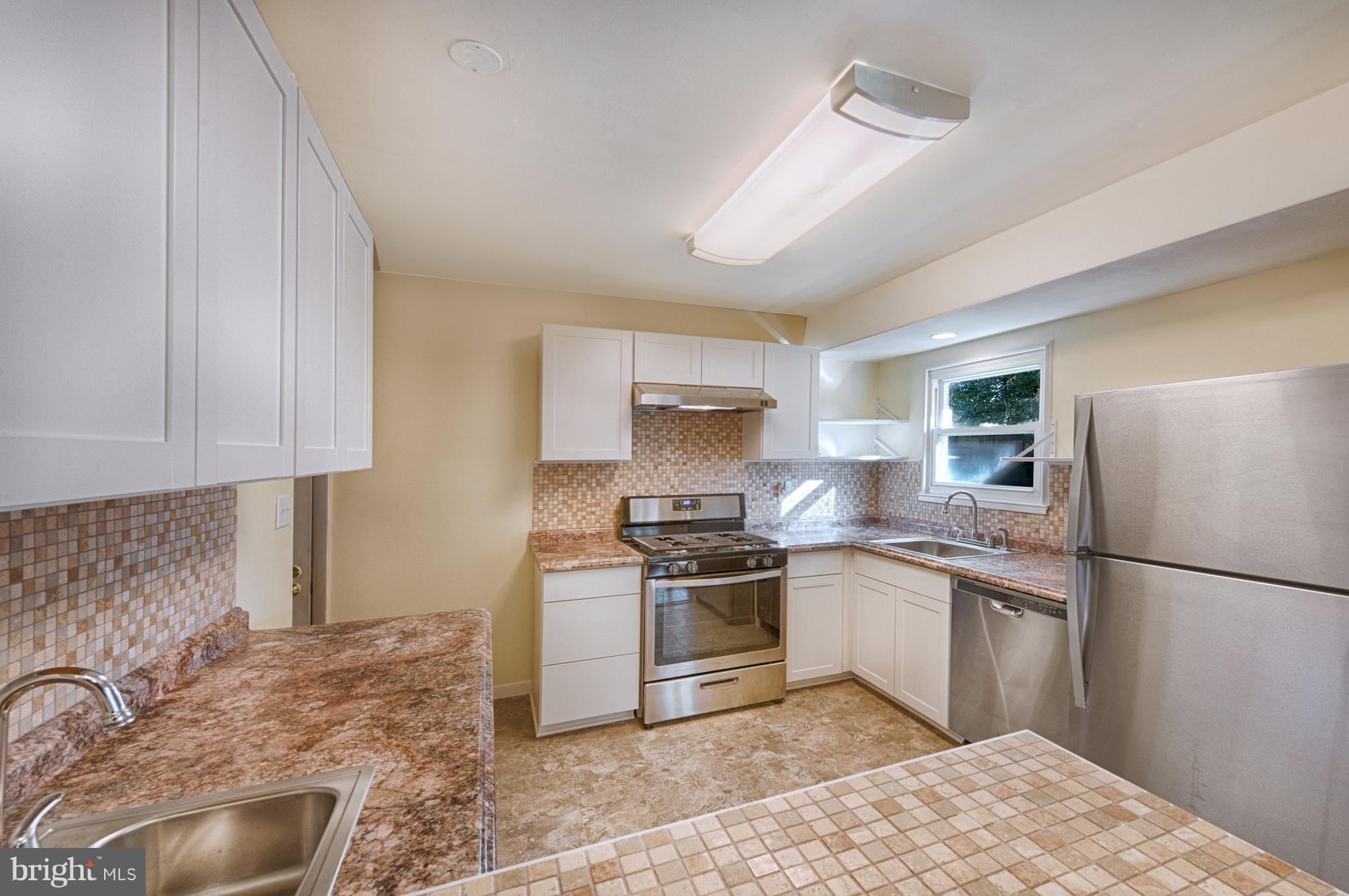 529 Crisfield Road Baltimore, MD 21220 - Photo 7 of 19 a kitchen with stainless steel appliances granite countertop a sink stove and refrigerator