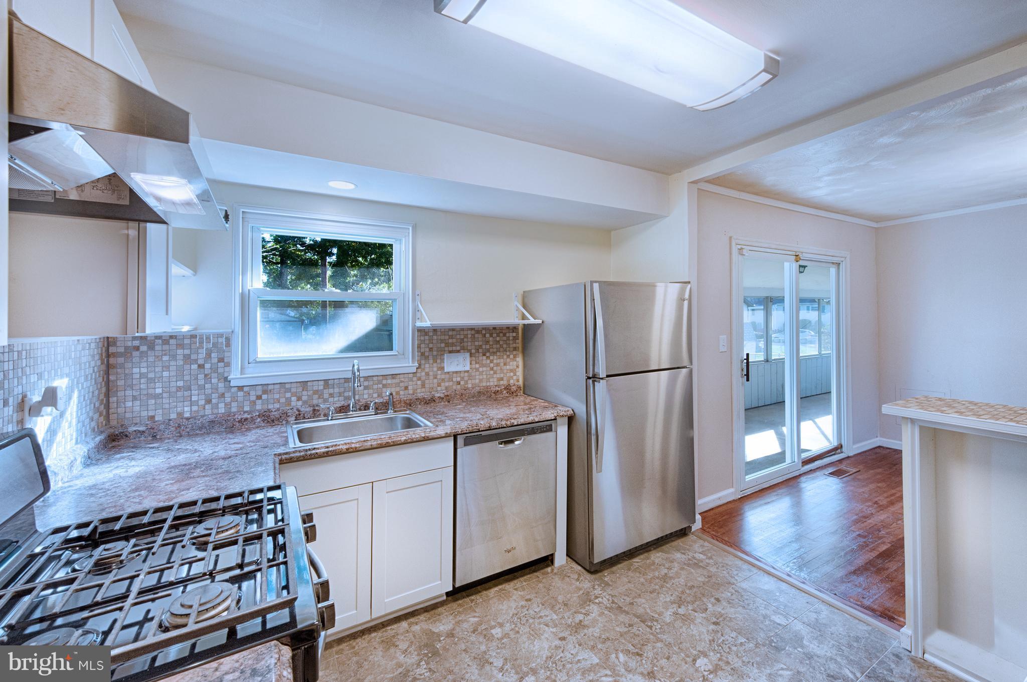 529 Crisfield Road Baltimore, MD 21220 - Photo 8 of 19 a kitchen with stainless steel appliances granite countertop a refrigerator stove and sink