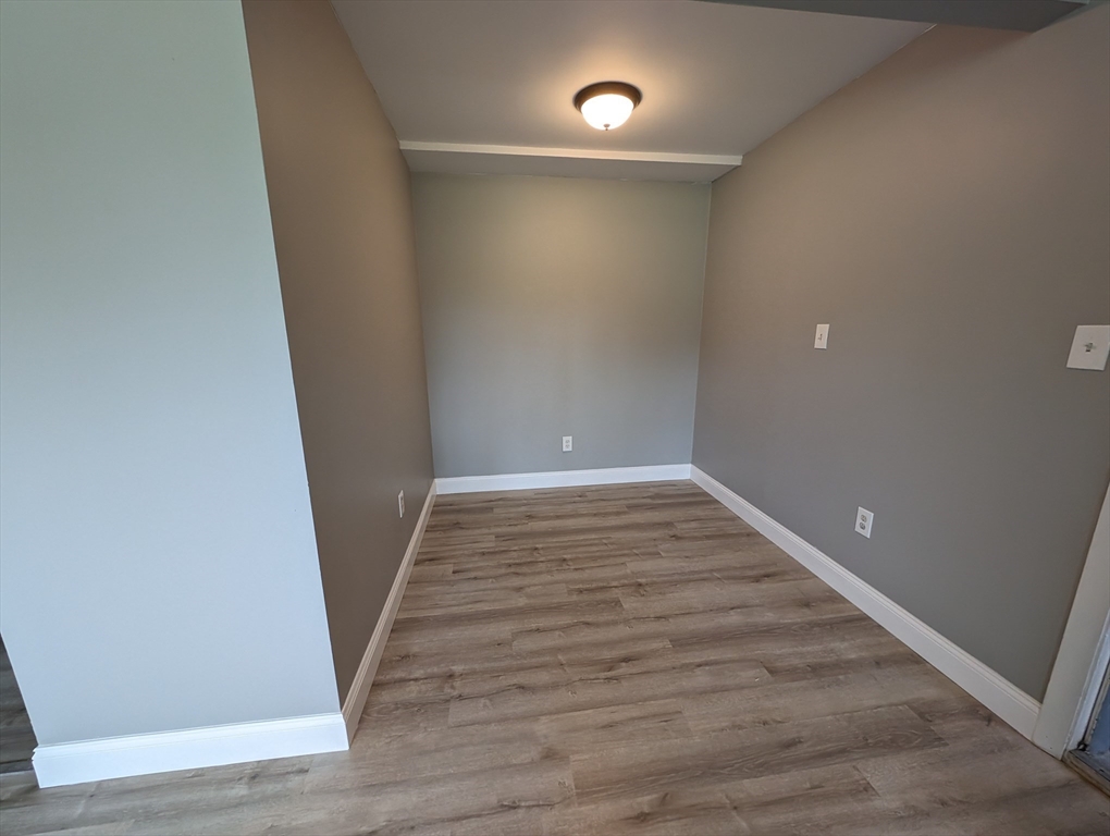 191 Glasgow Street, Unit 3 Fall River, MA 02721 - Photo 12 of 16 a view of an empty room with wooden floor