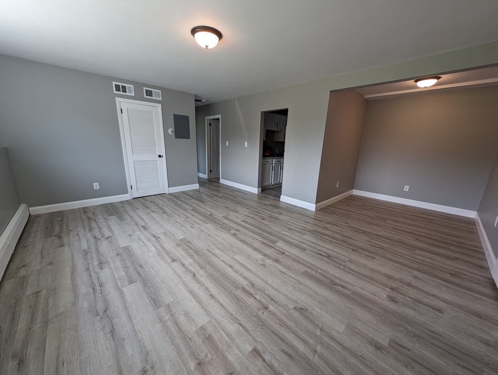 191 Glasgow Street, Unit 3 Fall River, MA 02721 - Photo 3 of 16 a view of an empty room with wooden floor