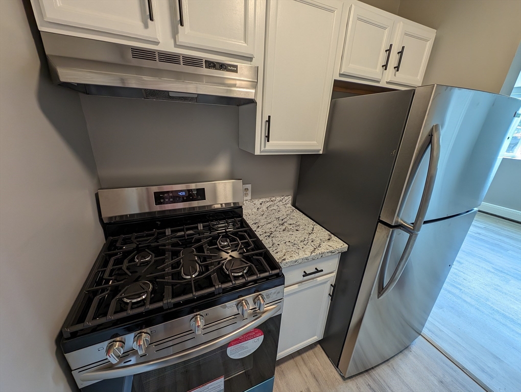 191 Glasgow Street, Unit 3 Fall River, MA 02721 - Photo 5 of 16 a kitchen with a stove and a refrigerator