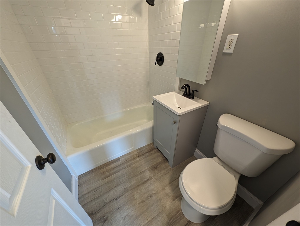 191 Glasgow Street, Unit 3 Fall River, MA 02721 - Photo 8 of 16 a white toilet sitting next to a bath tub
