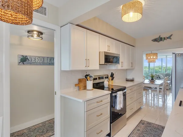a kitchen with a sink cabinets and window