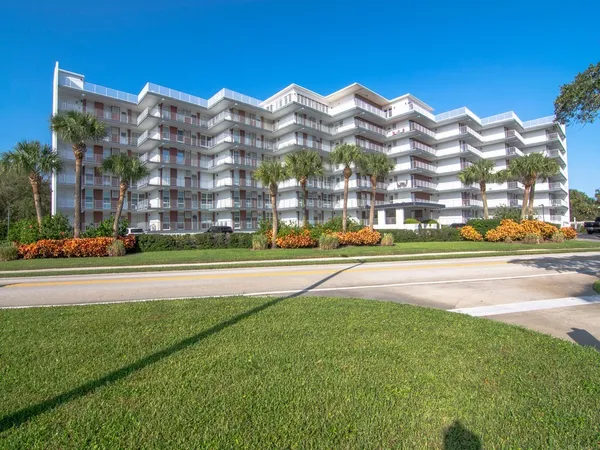 a view of building with a yard and a large building