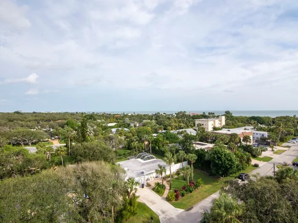 an aerial view of residential house with outdoor space and trees