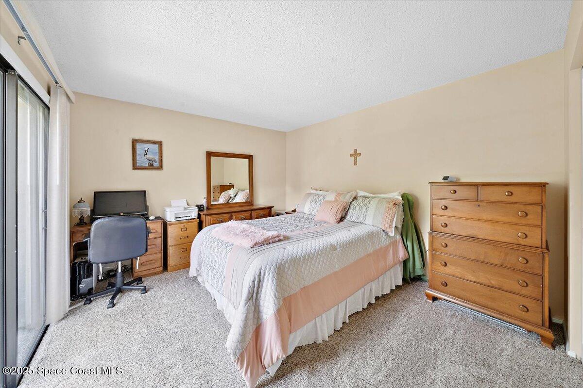 1713 Patty Circle Northeast Palm Bay, FL 32905 - Photo 18 of 26 a bedroom with a bed and dresser