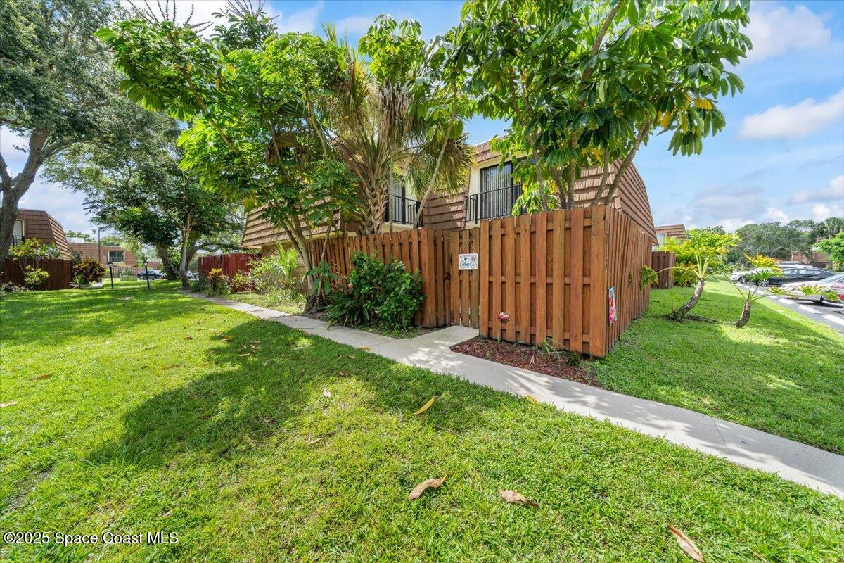 1713 Patty Circle Northeast Palm Bay, FL 32905 - Photo 25 of 26 a view of a backyard with large trees