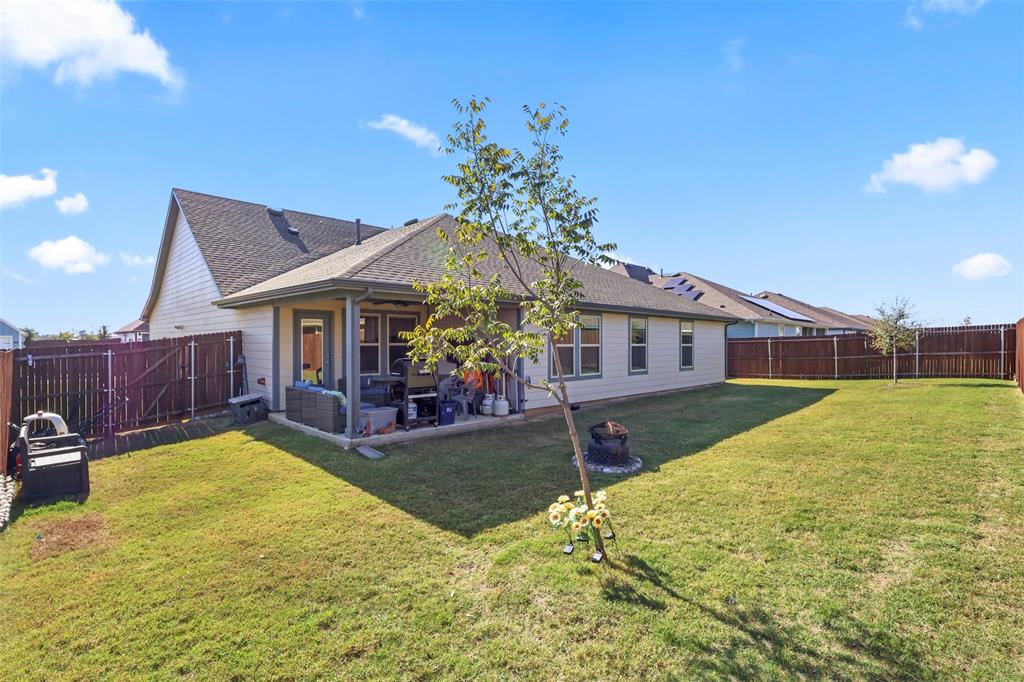 742 Buttercup Drive Pilot Point, TX 76258 - Photo 20 of 20 Rear view of house with a patio, a fenced backyard, and a shingled roof