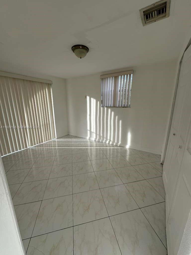 4801 Northwest 7th Street, Unit 21016 Miami, FL 33126 - Photo 11 of 18 a view of an empty room and window