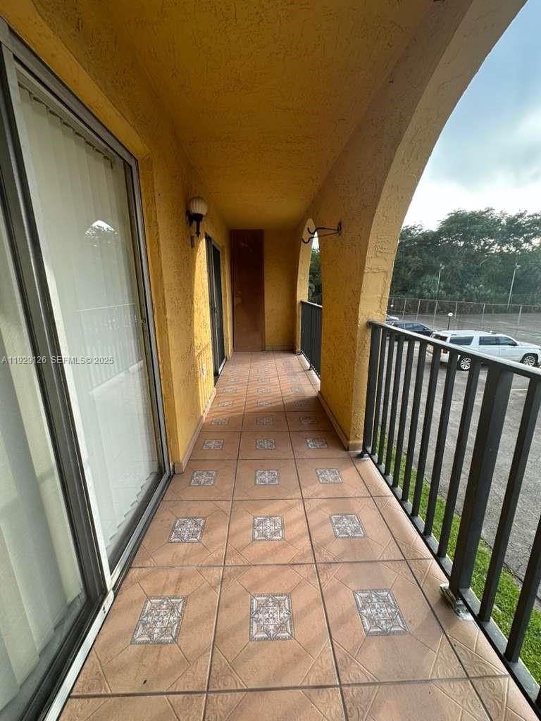 4801 Northwest 7th Street, Unit 21016 Miami, FL 33126 - Photo 5 of 18 a view hallway with wooden floor and door
