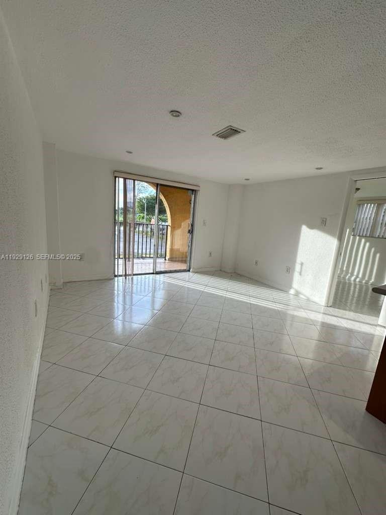 4801 Northwest 7th Street, Unit 21016 Miami, FL 33126 - Photo 6 of 18 a view of an empty room and window