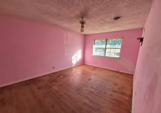 an empty room with windows and closet