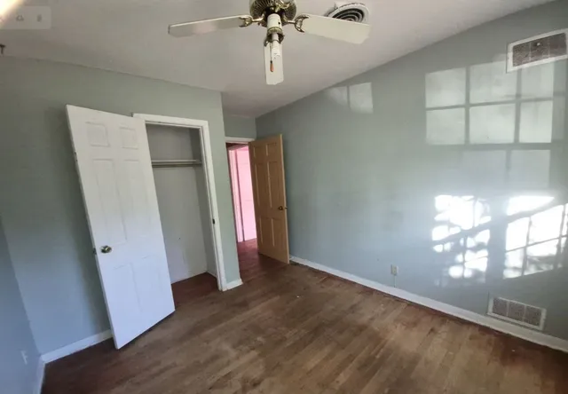 a view of a room with wooden floor and staircase