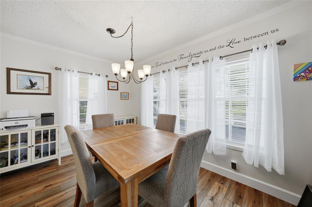 10303 Burnt Store Road, Unit 143 Punta Gorda, FL 33950 - Photo 7 of 42 a view of a dining room with furniture window and wooden floor