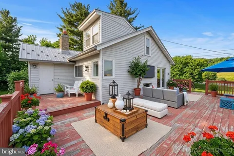 a view of a house with a yard and deck