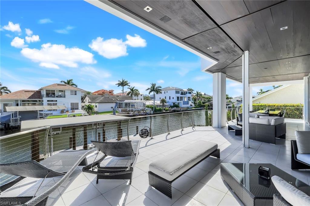 260 Channel Drive Naples, FL 34108 - Photo 12 of 48 a balcony with furniture and city view
