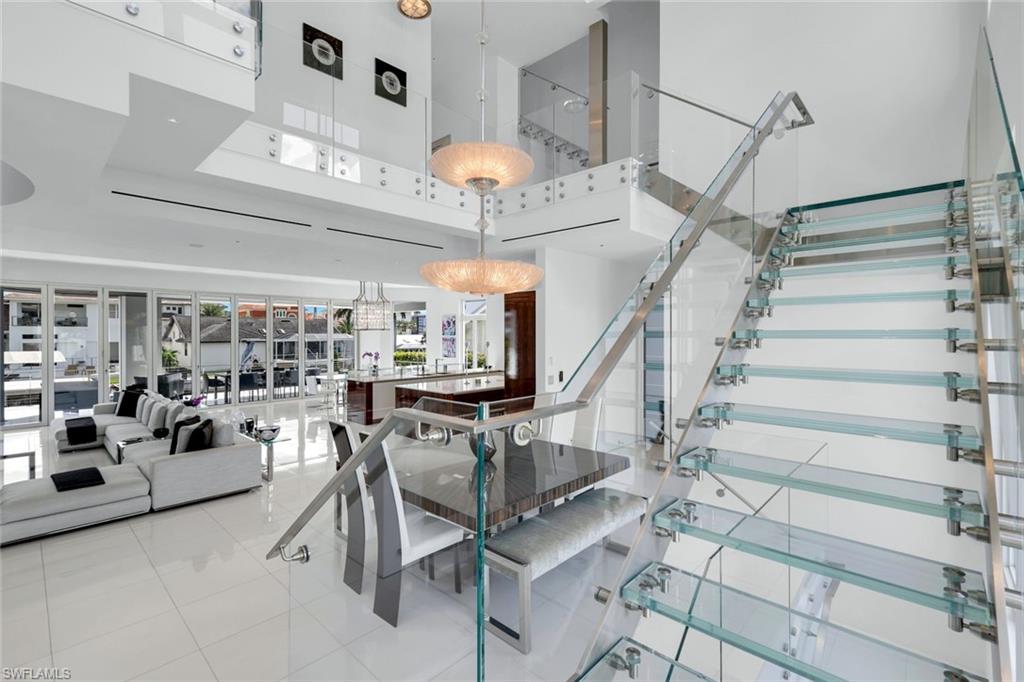 260 Channel Drive Naples, FL 34108 - Photo 15 of 48 a view of a room with lots of white furniture and a chandelier