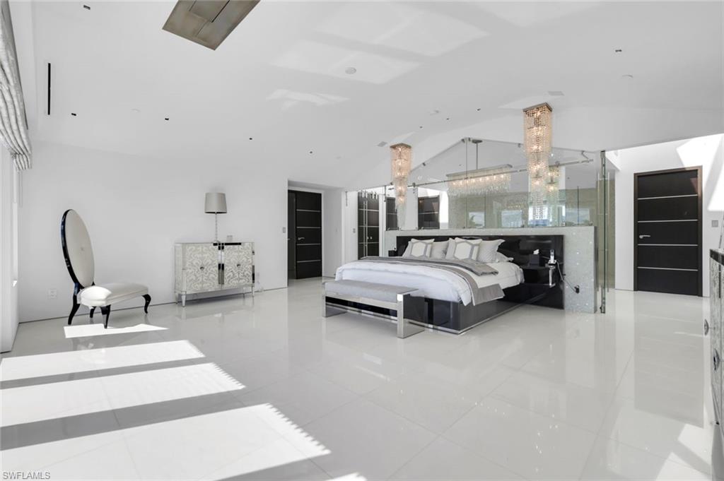 260 Channel Drive Naples, FL 34108 - Photo 17 of 48 a bedroom with furniture and a chandelier