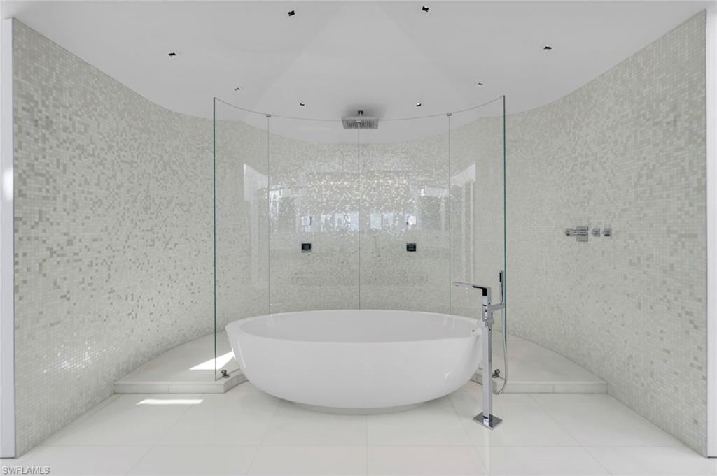 260 Channel Drive Naples, FL 34108 - Photo 18 of 48 a bathroom with a tub and a shower
